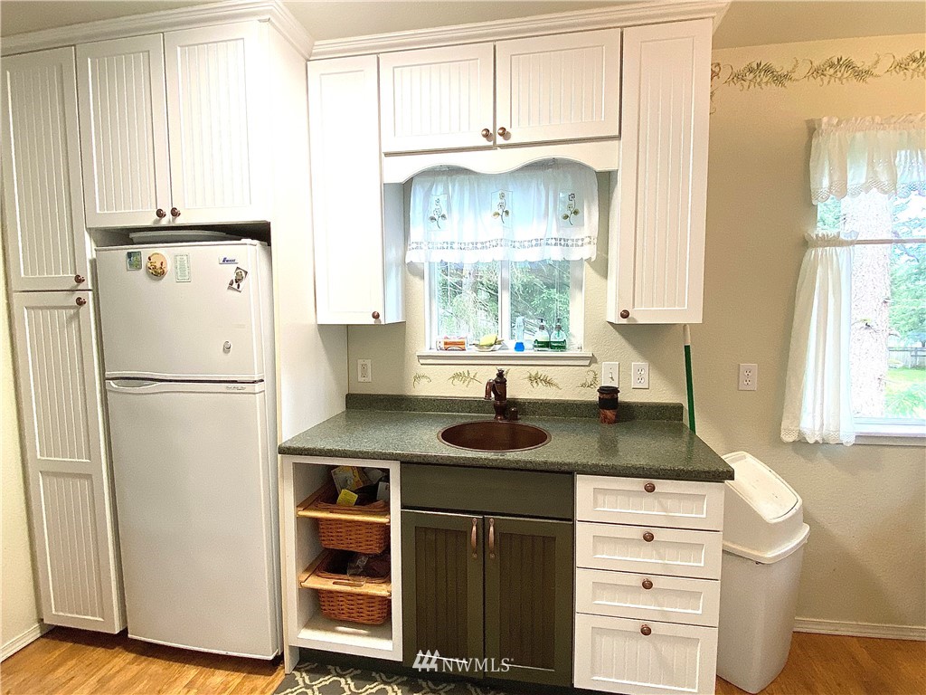 18436 Loganberry Street Southwest Rochester, WA 98579 - Photo 22 of 29 a kitchen with appliances cabinets and a window