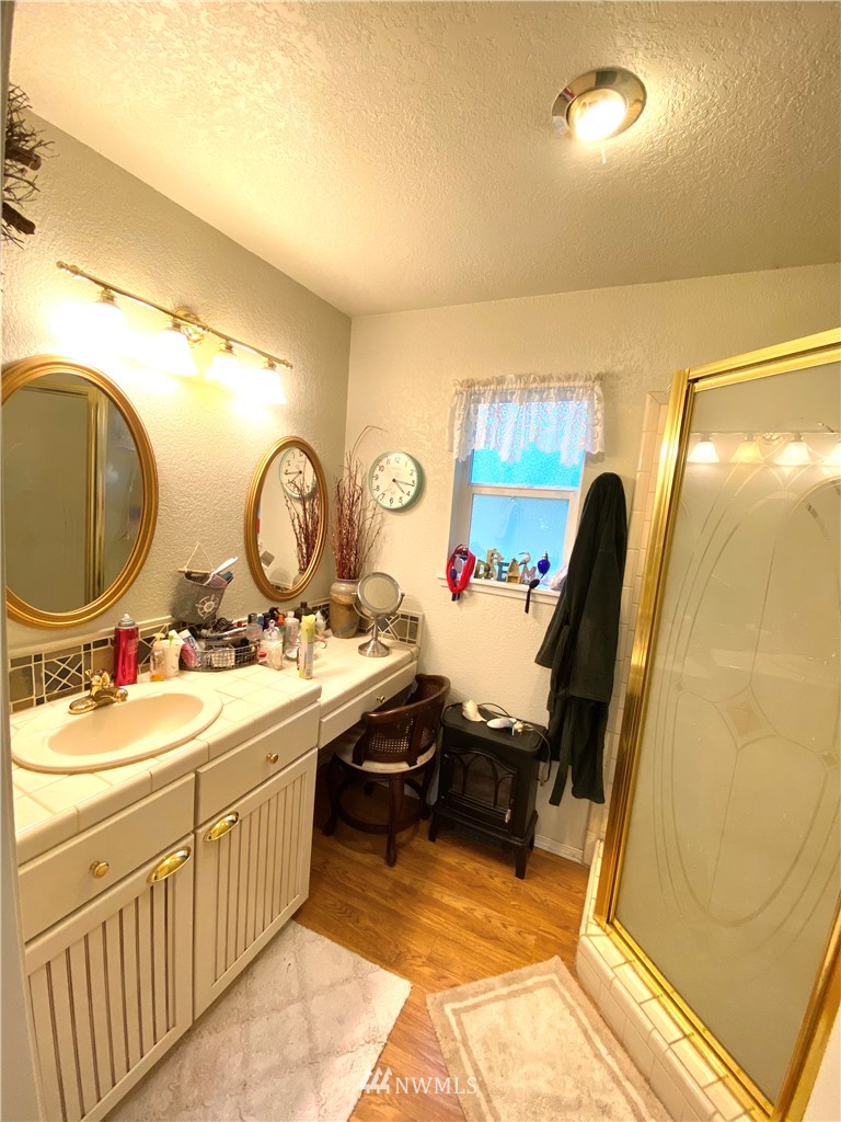 18436 Loganberry Street Southwest Rochester, WA 98579 - Photo 23 of 29 a view of a bathroom with dual sinks