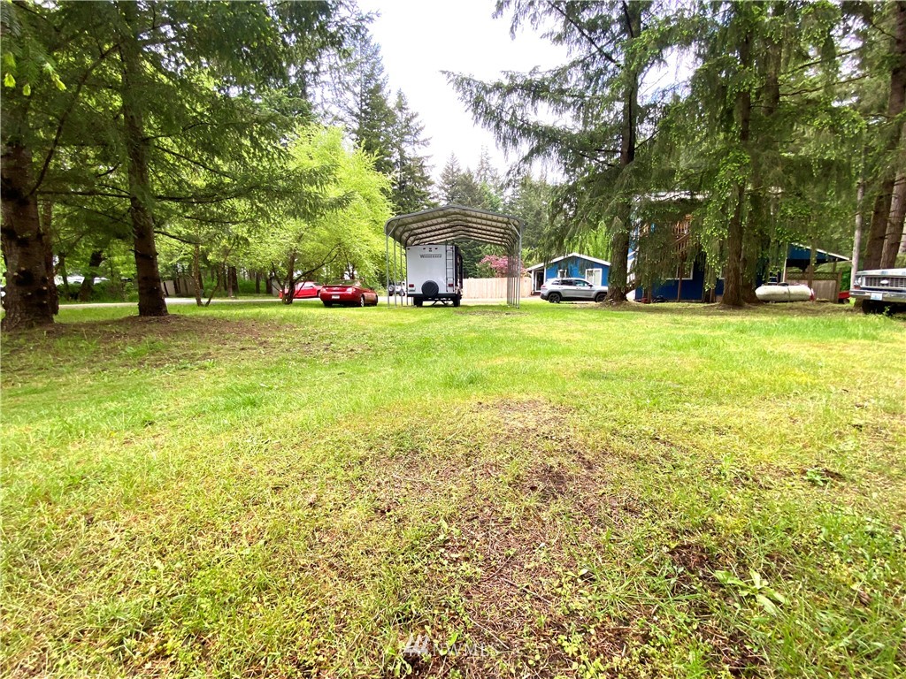 18436 Loganberry Street Southwest Rochester, WA 98579 - Photo 29 of 29 a front view of a house with a big yard and large trees