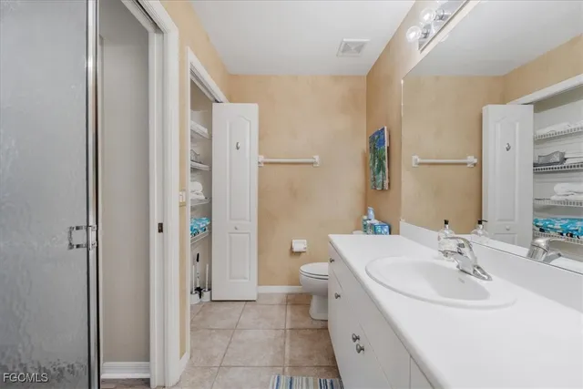 a bathroom with a sink vanity mirror and toilet