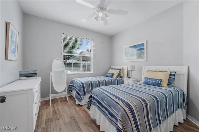 a bedroom with two beds and a chandelier