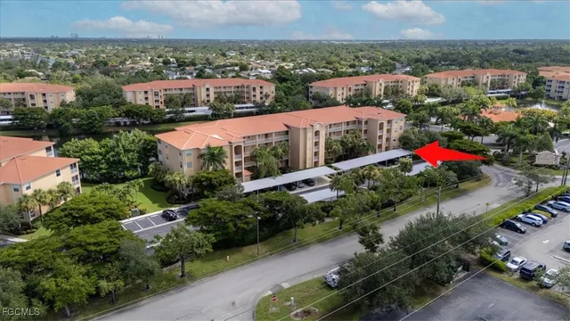 an aerial view of residential houses with outdoor space and lake view