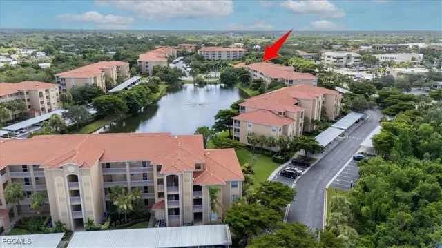 an aerial view of house with yard and lake view