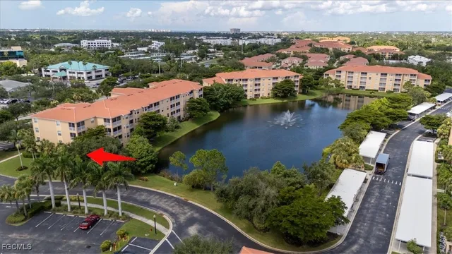 an aerial view of house with yard and lake view