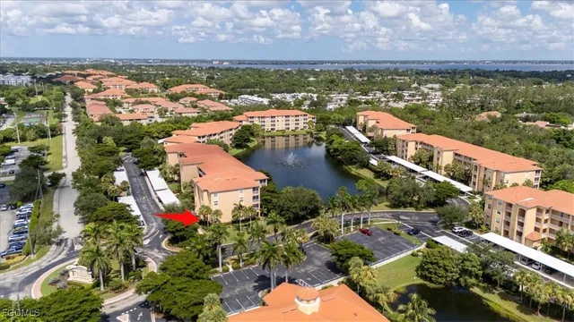 an aerial view of residential houses with outdoor space and lake view