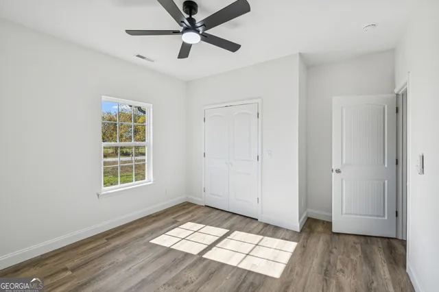 a bathroom with a granite countertop sink a toilet and a mirror