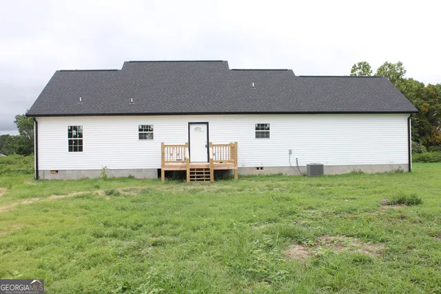 an aerial view of a house with backyard