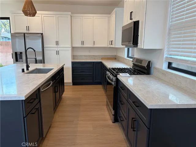 a kitchen with a sink stove and cabinets