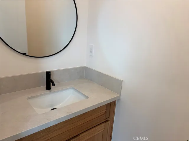 a bathroom with a sink and mirror