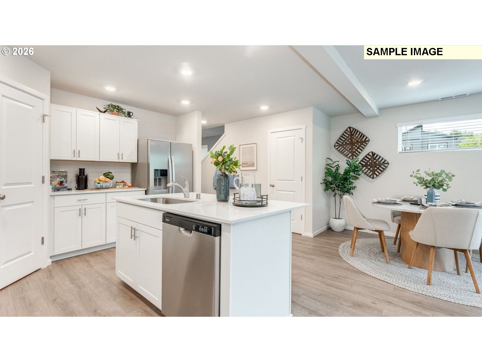 134 Coho Loop Woodland, WA 98674 - Photo 2 of 23 a kitchen with white cabinets and potted plant