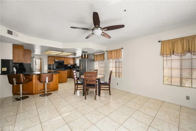 a kitchen with stainless steel appliances granite countertop a refrigerator a oven and a sink