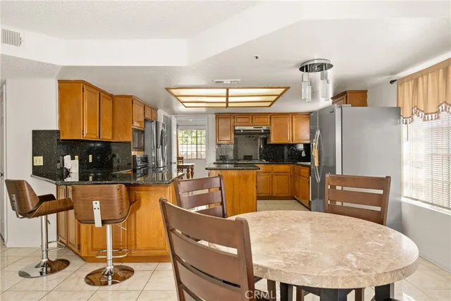 a kitchen with stainless steel appliances granite countertop sink stove top oven and cabinets
