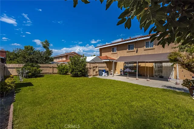 a kitchen with stainless steel appliances kitchen island granite countertop a refrigerator a stove a sink dishwasher with a dining table and chairs with wooden floor