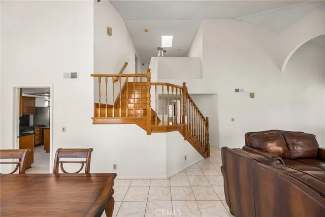 a kitchen with stainless steel appliances granite countertop a refrigerator a oven and a sink