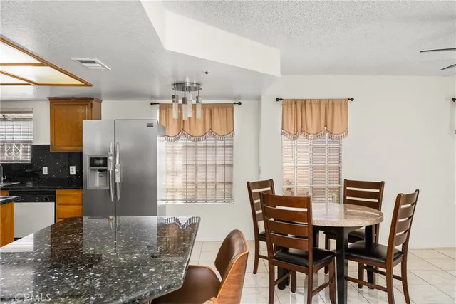 a kitchen with stainless steel appliances granite countertop sink stove top oven and cabinets