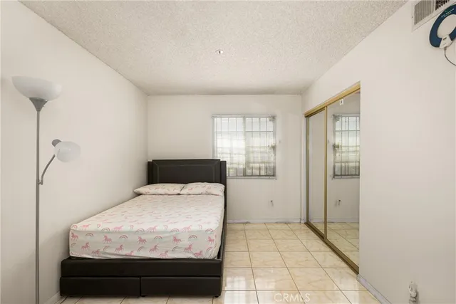 a spacious bathroom with a double vanity sink a mirror and a shower