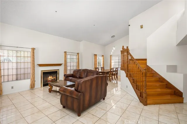 a view of staircase with lots of frames on wall and windows