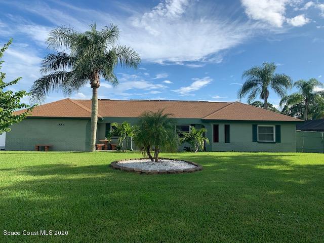 1554 Meadowbrook Road Northeast Palm Bay, FL 32905 - Photo 1 of 37 a view of a house with a yard