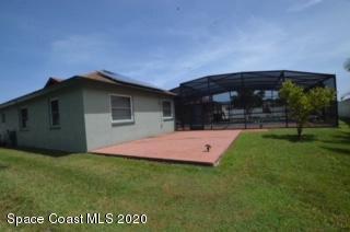 1554 Meadowbrook Road Northeast Palm Bay, FL 32905 - Photo 12 of 37 a front view of house with yard and green space