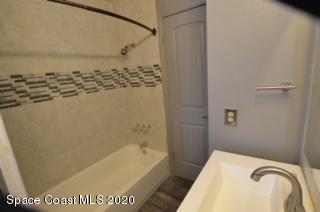 1554 Meadowbrook Road Northeast Palm Bay, FL 32905 - Photo 13 of 37 a bathroom with a bathtub and shower