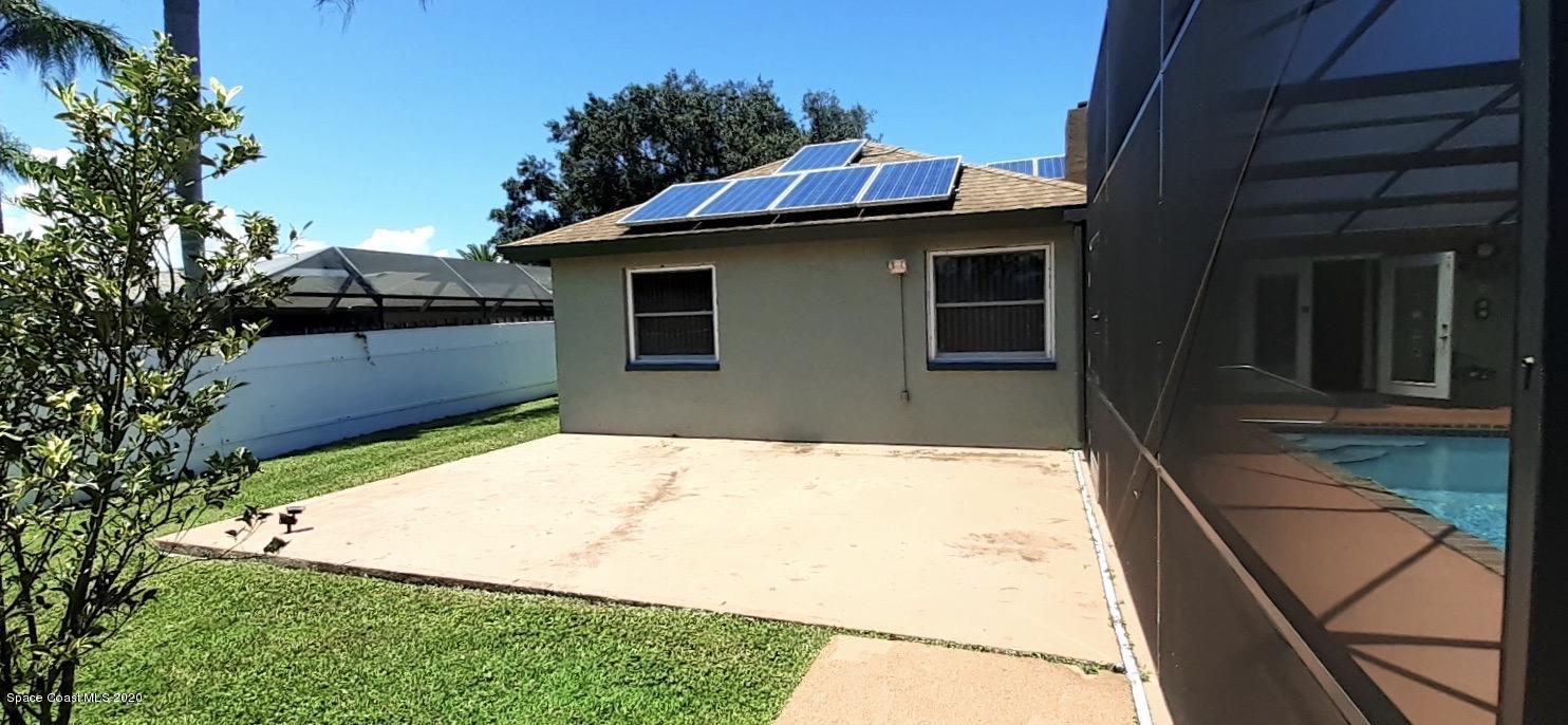 1554 Meadowbrook Road Northeast Palm Bay, FL 32905 - Photo 24 of 37 a front view of a house with garage