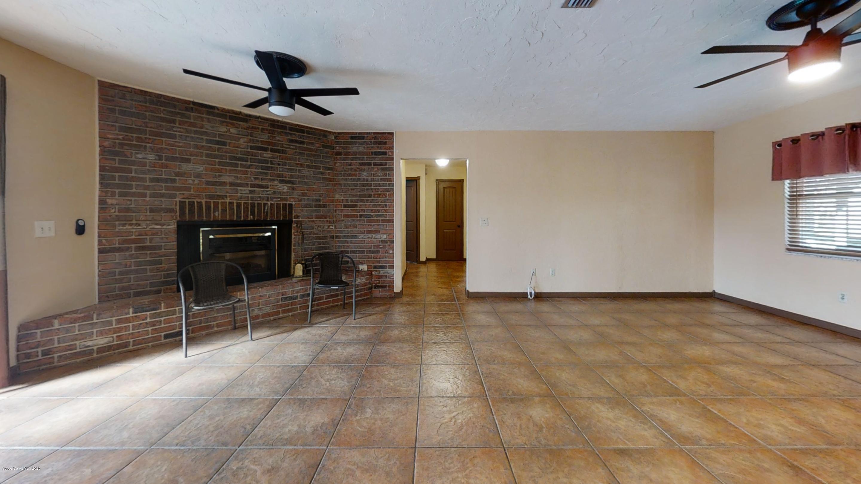 1554 Meadowbrook Road Northeast Palm Bay, FL 32905 - Photo 27 of 37 a view of a livingroom with a fireplace and window