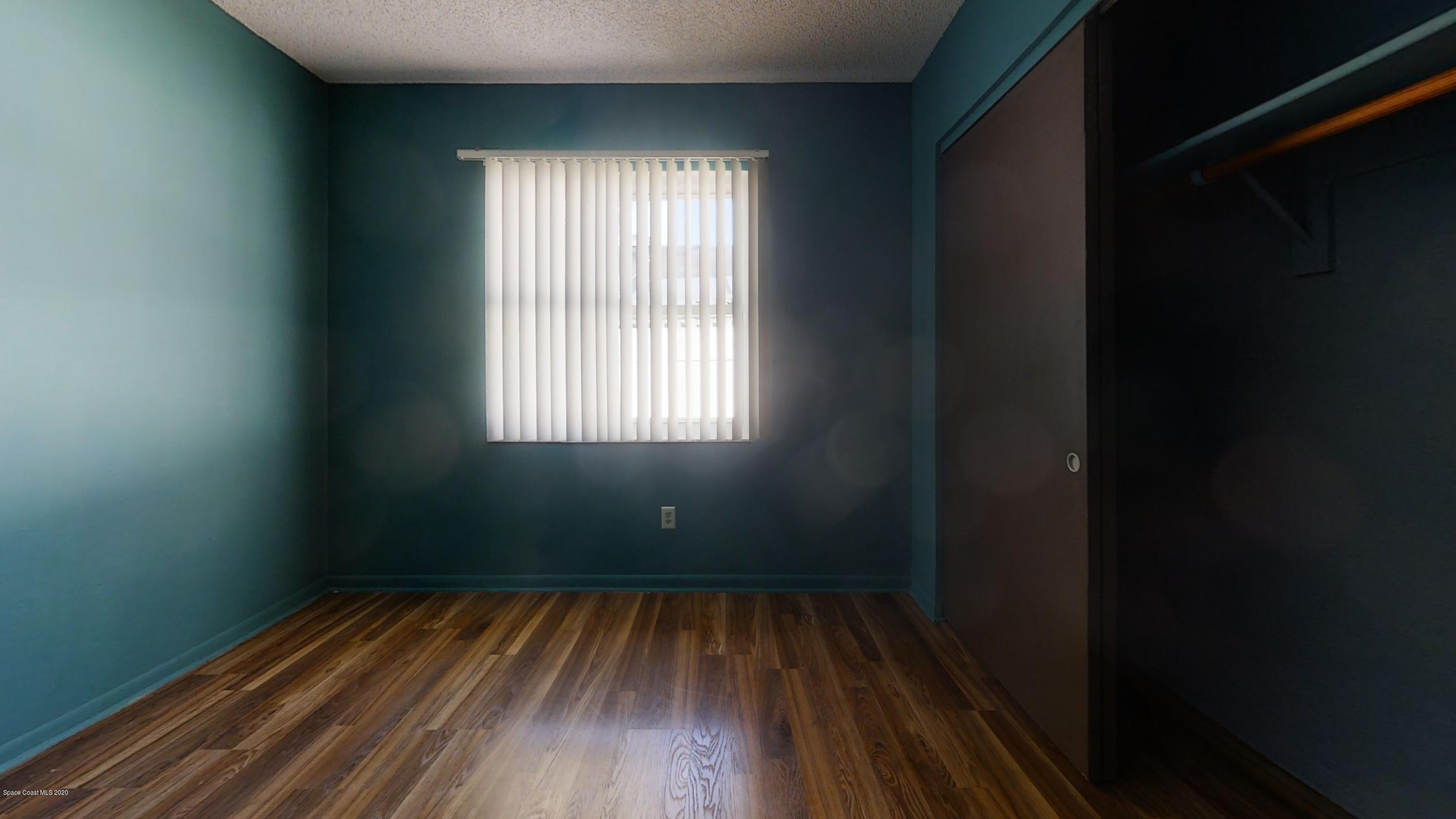 1554 Meadowbrook Road Northeast Palm Bay, FL 32905 - Photo 32 of 37 a view of a room with wooden floor and a window