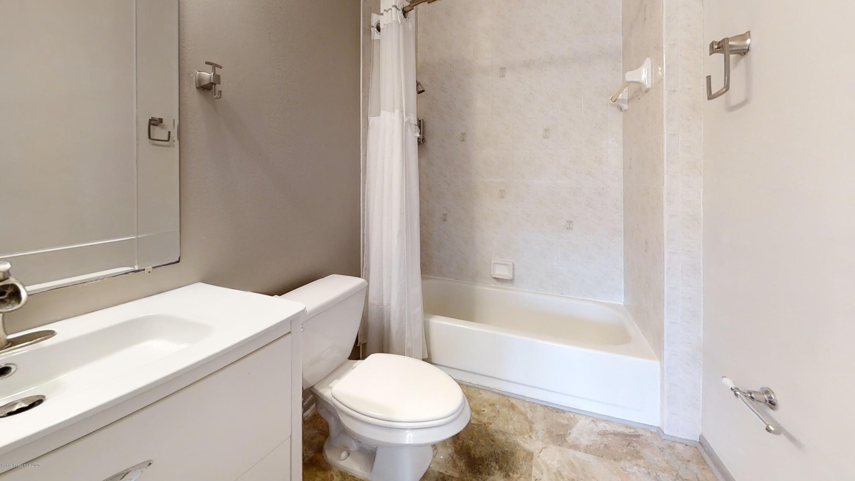 1554 Meadowbrook Road Northeast Palm Bay, FL 32905 - Photo 33 of 37 a bathroom with a sink toilet and shower