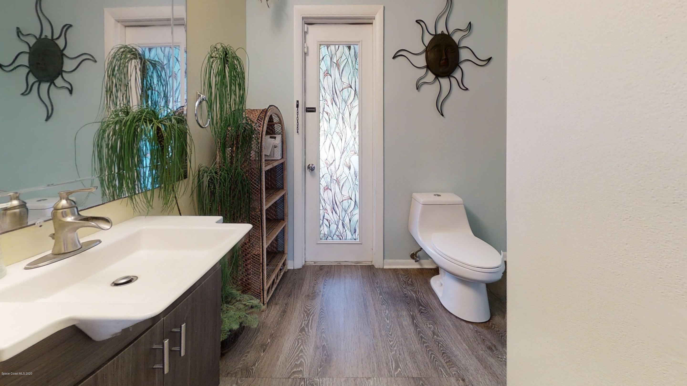1554 Meadowbrook Road Northeast Palm Bay, FL 32905 - Photo 34 of 37 a bathroom with a sink a toilet and shower