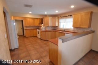 1554 Meadowbrook Road Northeast Palm Bay, FL 32905 - Photo 8 of 37 a kitchen with stainless steel appliances granite countertop a sink a stove and a refrigerator