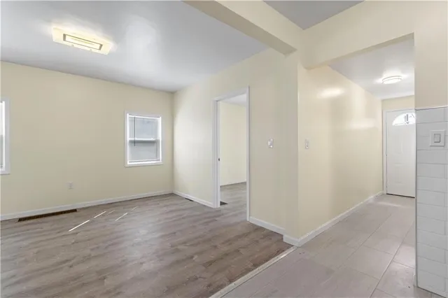 wooden floor in an empty room with a window