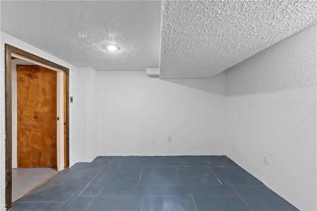 a view of an empty room with gym equipment