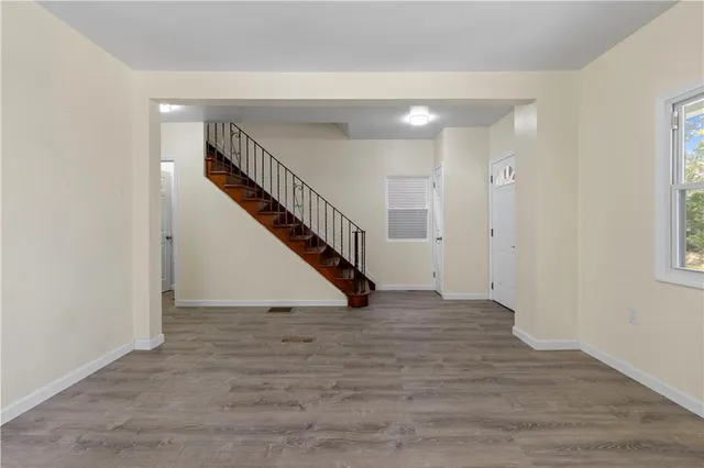 a view of an entryway with wooden floor