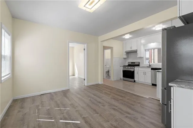 a large kitchen with a refrigerator and a stove top oven