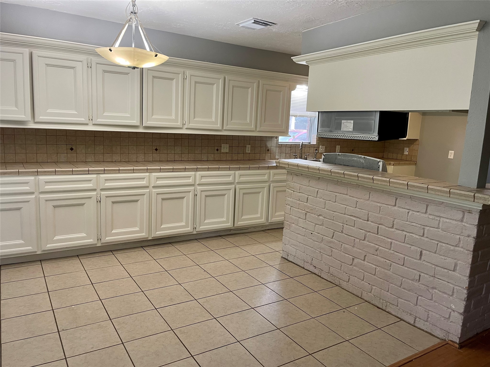 15803 Baytree Drive Houston, TX 77070 - Photo 11 of 23 a kitchen with white cabinets