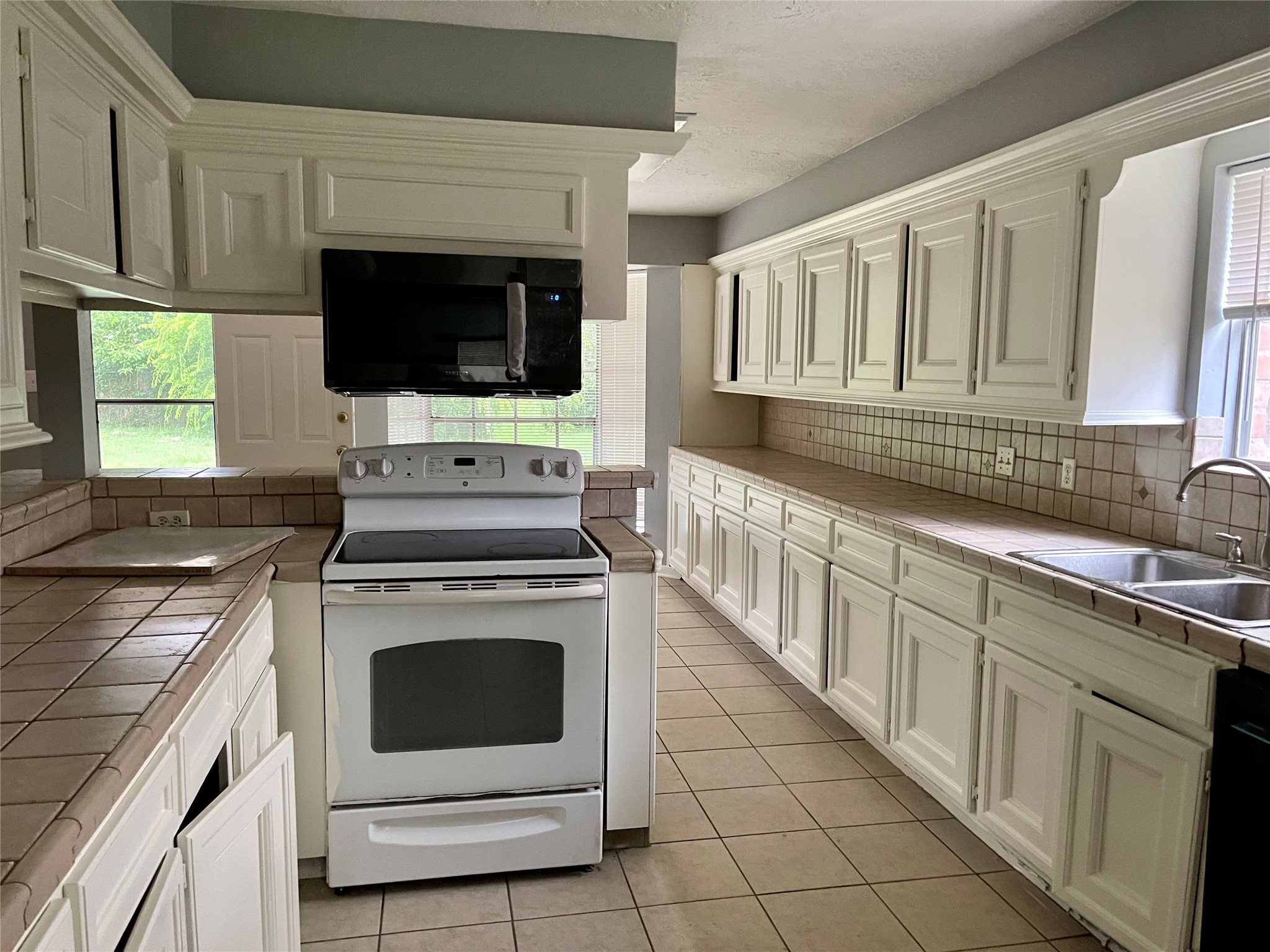 15803 Baytree Drive Houston, TX 77070 - Photo 13 of 23 a kitchen with stainless steel appliances granite countertop a stove microwave and sink