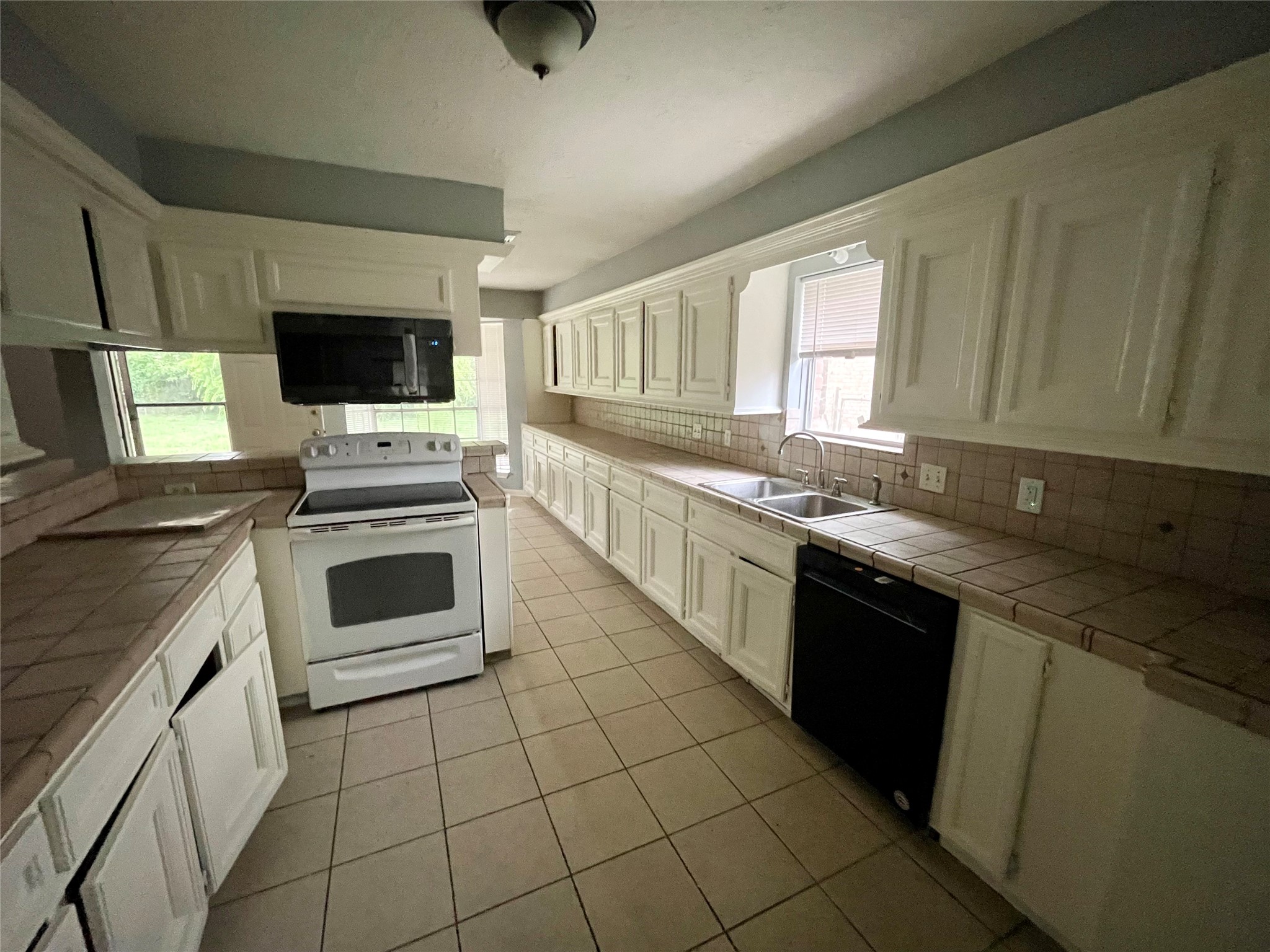 15803 Baytree Drive Houston, TX 77070 - Photo 14 of 23 a kitchen with stainless steel appliances granite countertop a stove sink and microwave