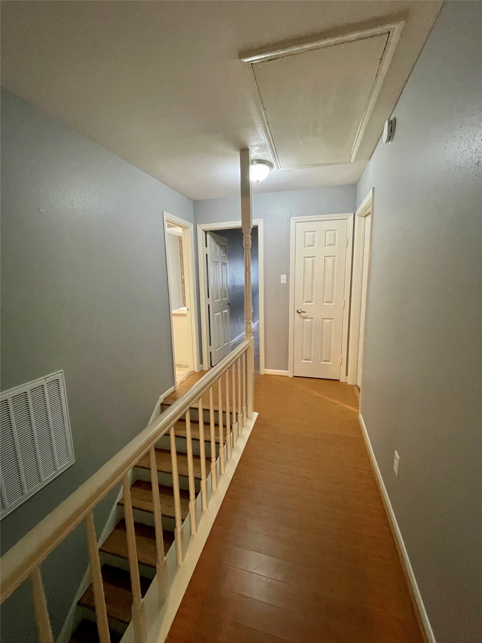 15803 Baytree Drive Houston, TX 77070 - Photo 15 of 23 a view of a hallway with wooden floor