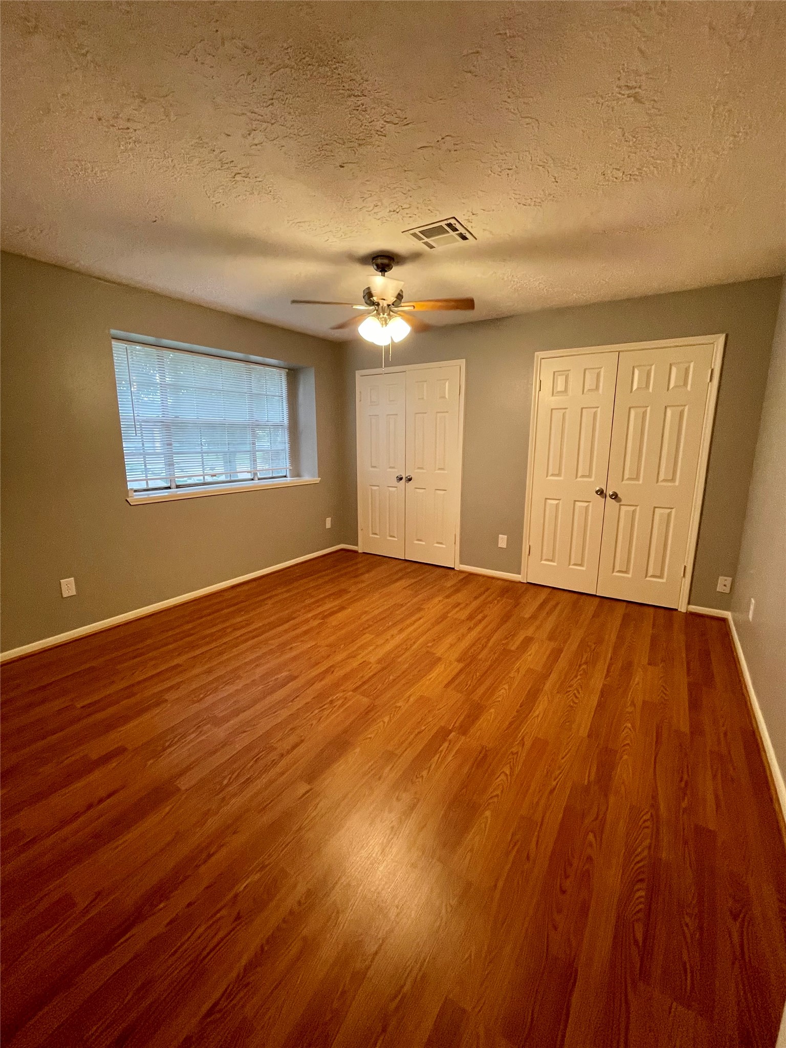 15803 Baytree Drive Houston, TX 77070 - Photo 19 of 23 a view of an empty room with wooden floor and a window