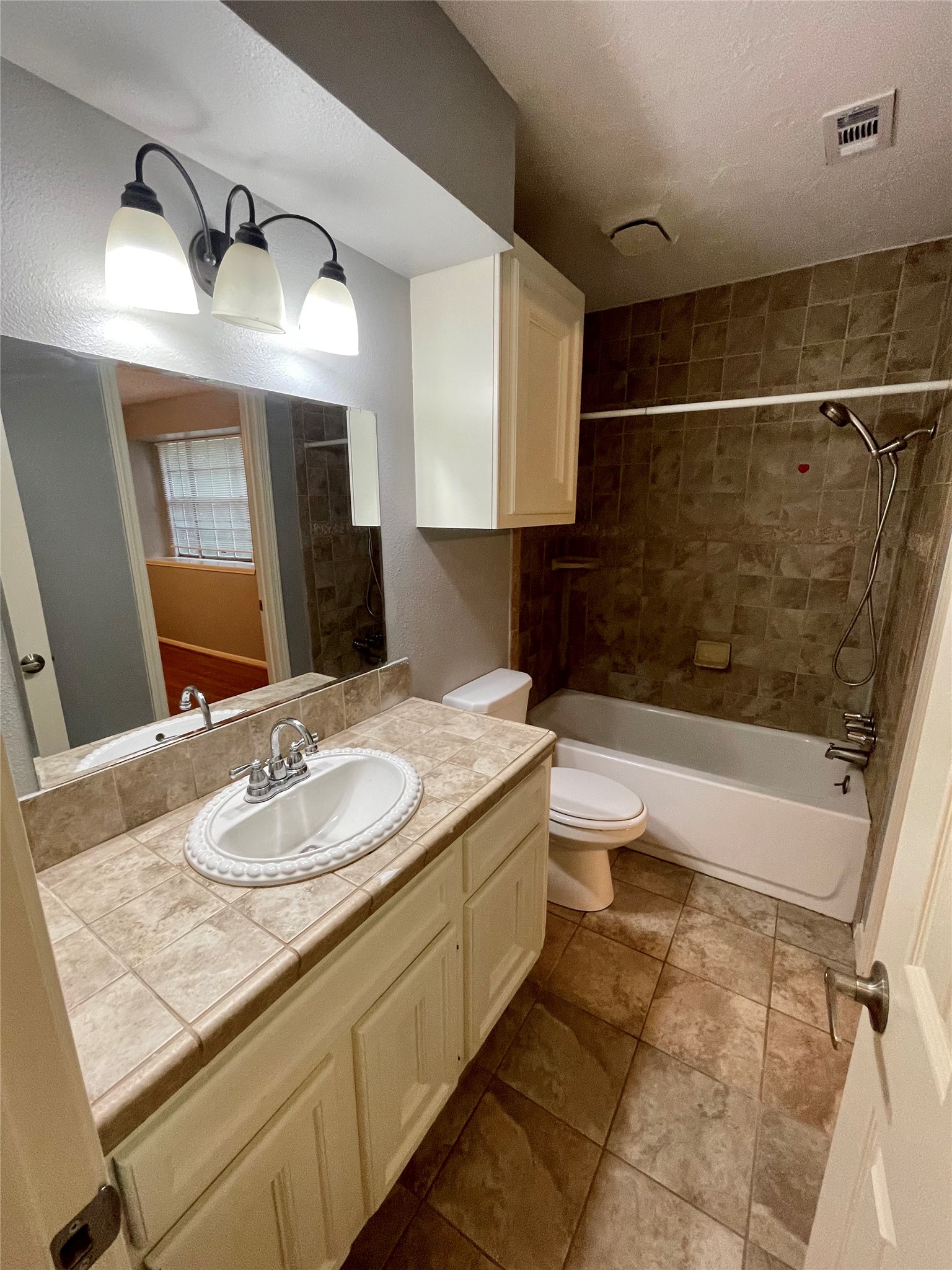 15803 Baytree Drive Houston, TX 77070 - Photo 22 of 23 a bathroom with a granite countertop sink toilet and shower
