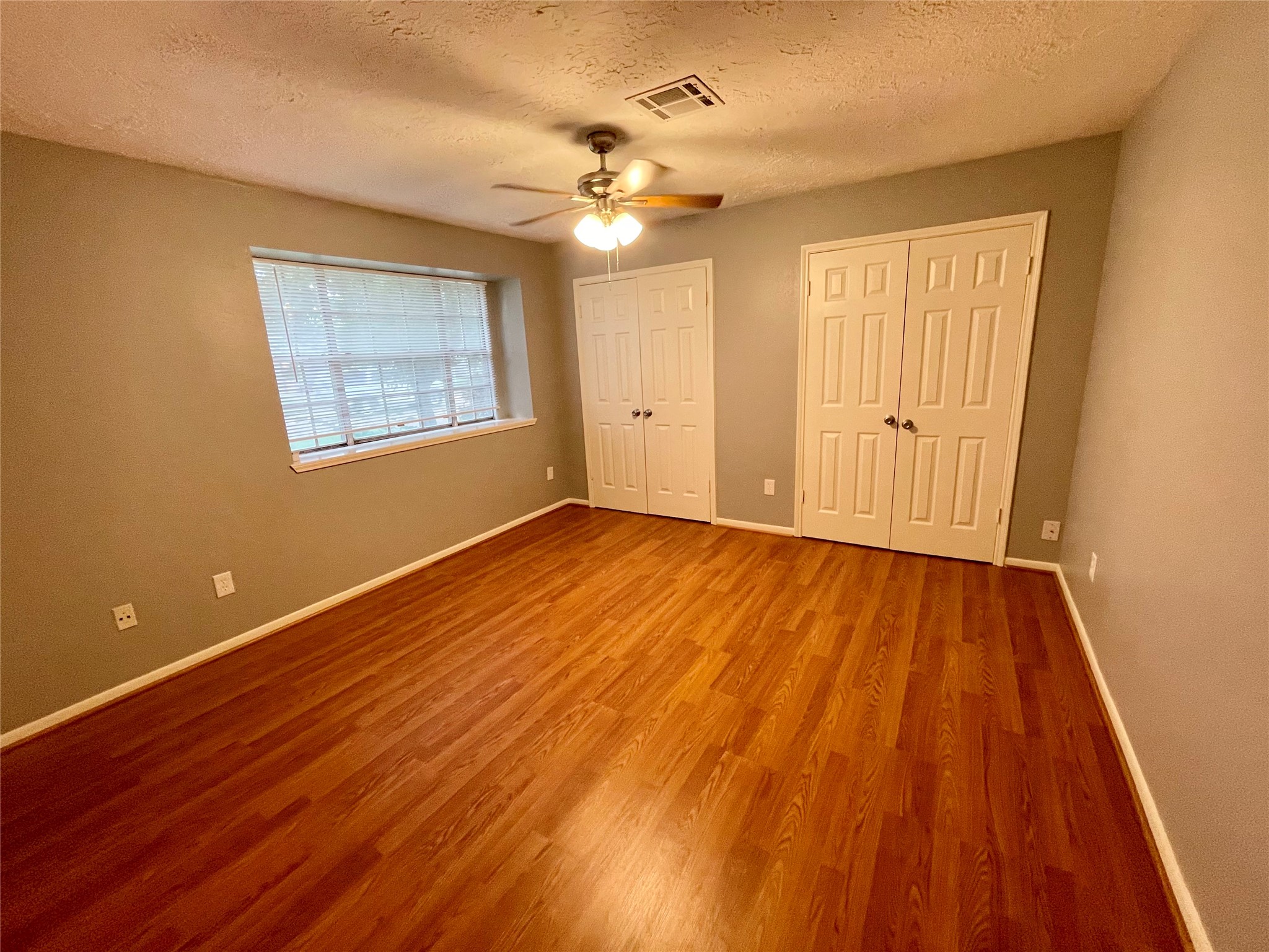 15803 Baytree Drive Houston, TX 77070 - Photo 23 of 23 a view of an empty room with wooden floor and a chandelier fan