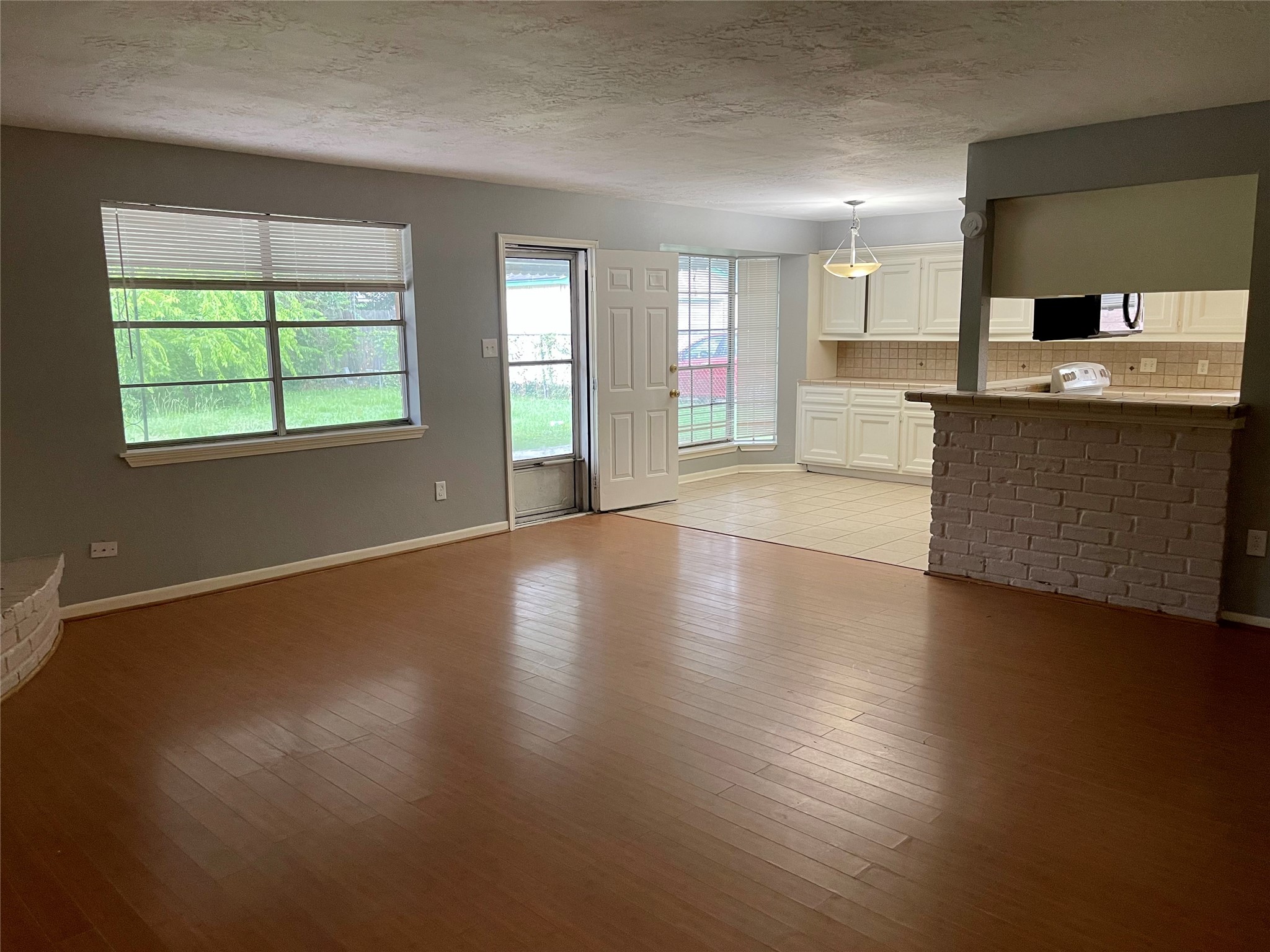 15803 Baytree Drive Houston, TX 77070 - Photo 3 of 23 an empty room with wooden floor and windows
