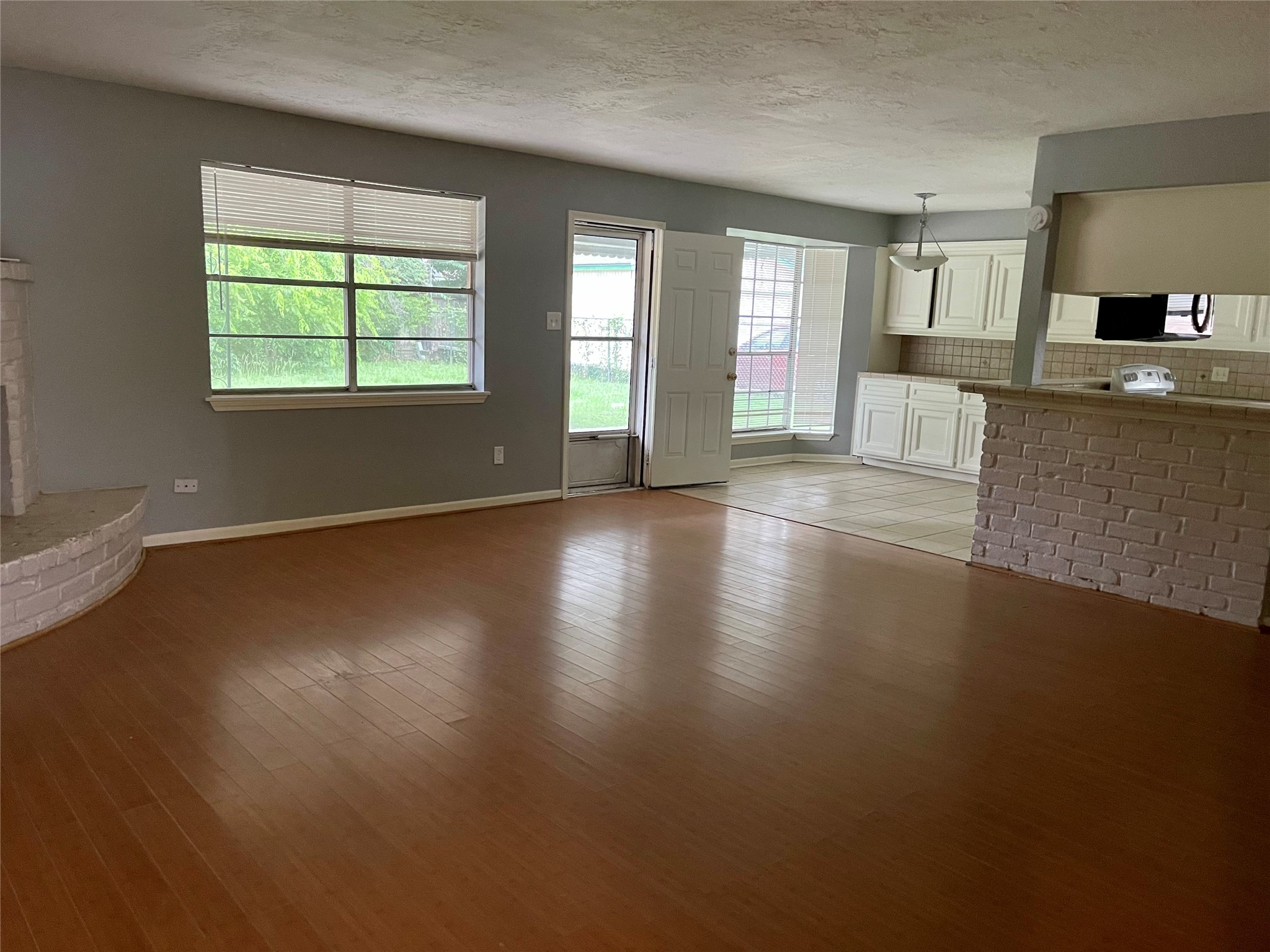 15803 Baytree Drive Houston, TX 77070 - Photo 4 of 23 an empty room with wooden floor and windows