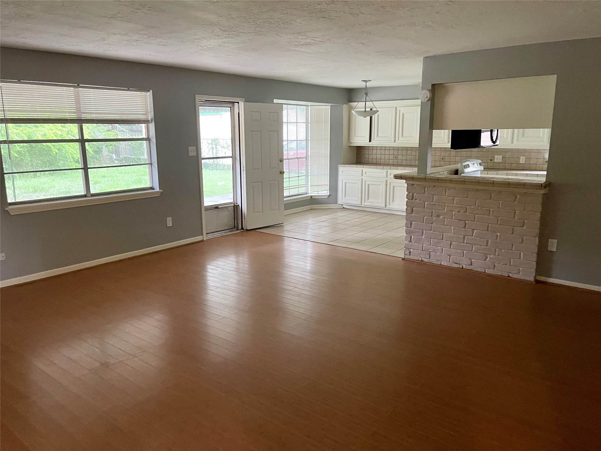 15803 Baytree Drive Houston, TX 77070 - Photo 6 of 23 an empty room with wooden floor and windows