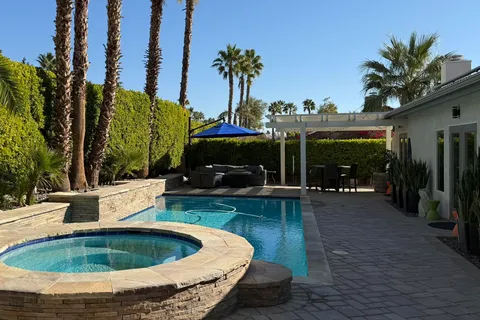 a view of a swimming pool with sitting area