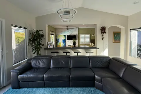 a living room with a table a flat screen tv and a fireplace