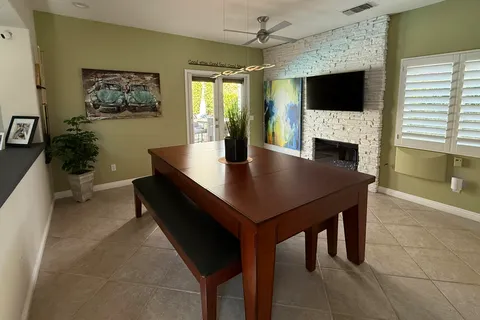 a room with pool table and windows