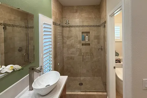 a bathroom with a sink mirror and toilet