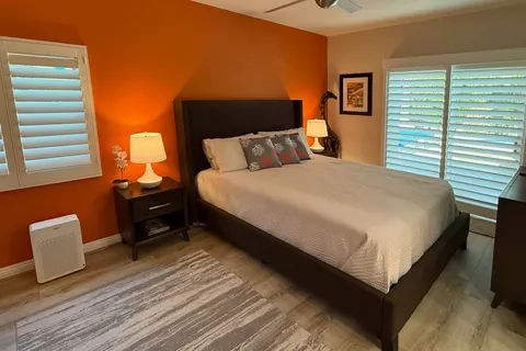 a bedroom with a bed and wooden floor