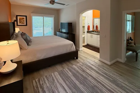 a bedroom with a bed and chair